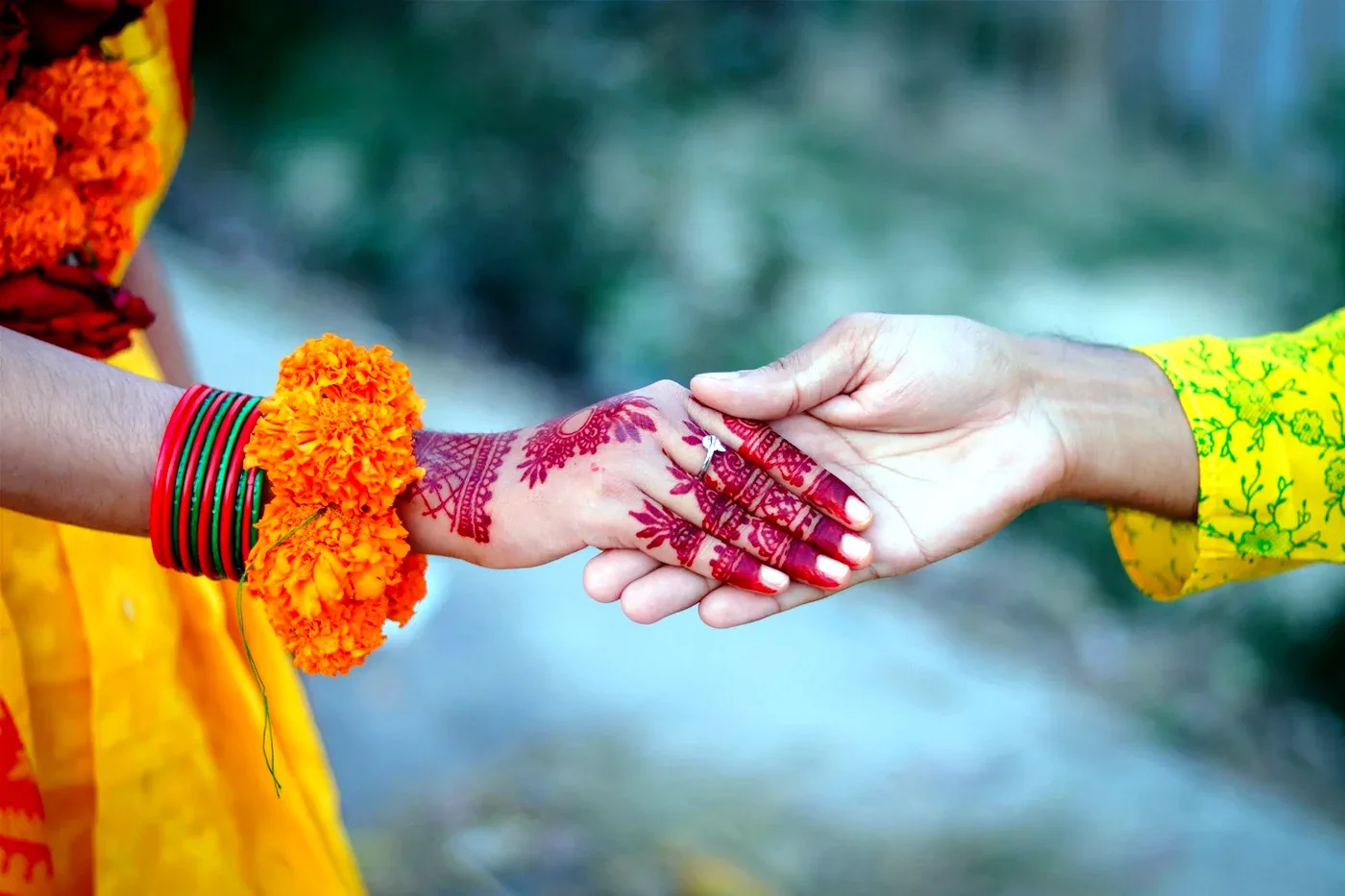 Mehendi function details with henna and marigold bangles