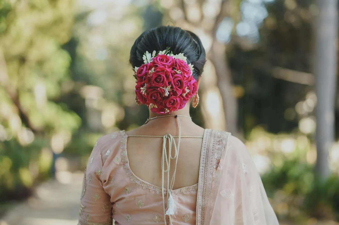 Woman with a flower tucked into her festive hairstyle